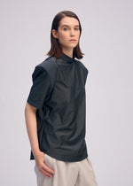 A model wears the ISSEY MIYAKE MUTE mute-shirt-light-grey.