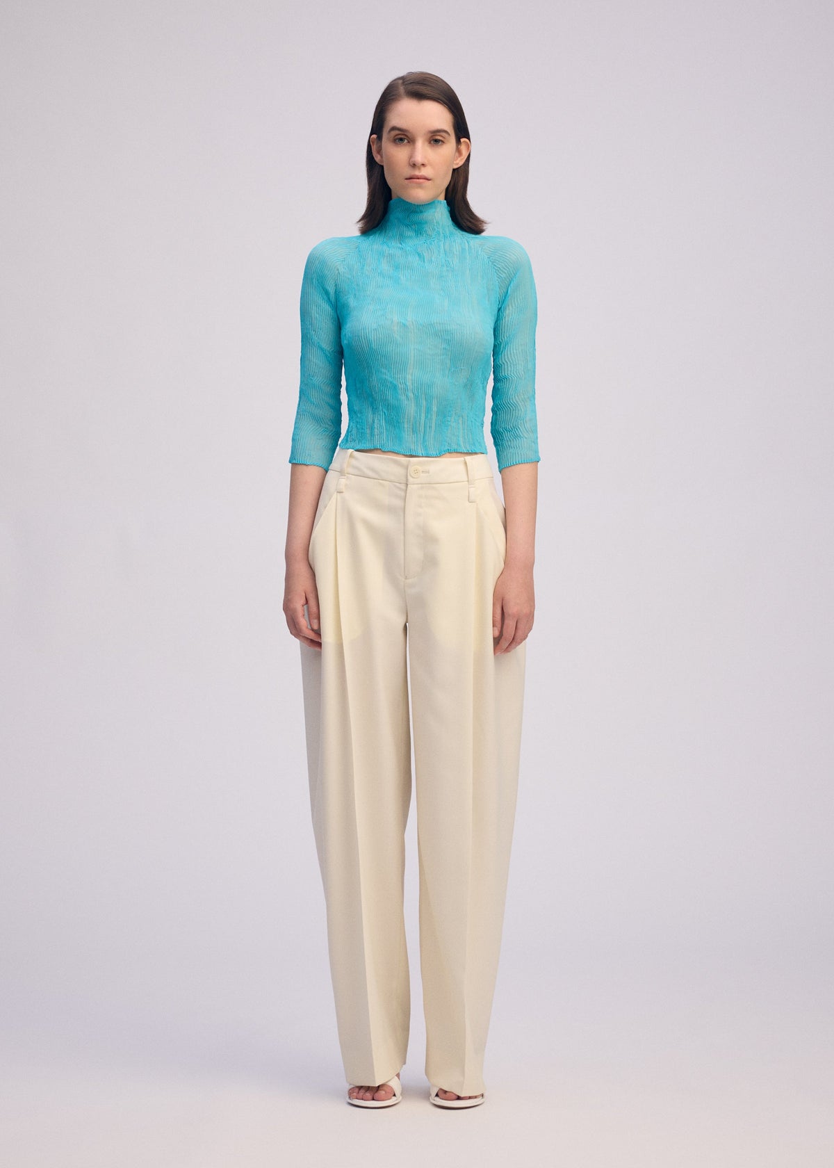 A model wears the ISSEY MIYAKE CHIFFON TWIST 2 shirt.
