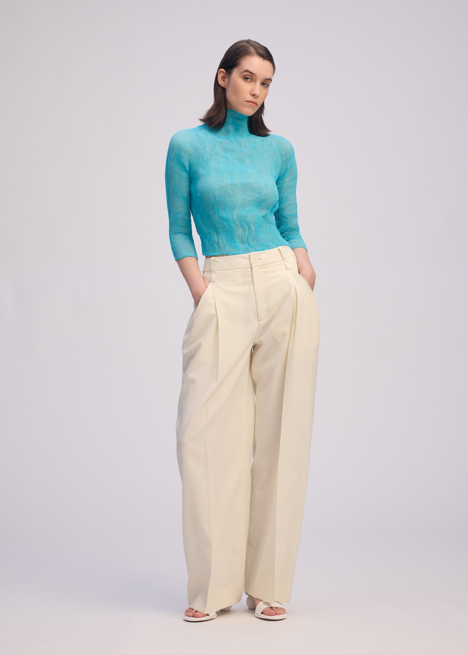 A model wears the ISSEY MIYAKE CHIFFON TWIST 2 shirt.