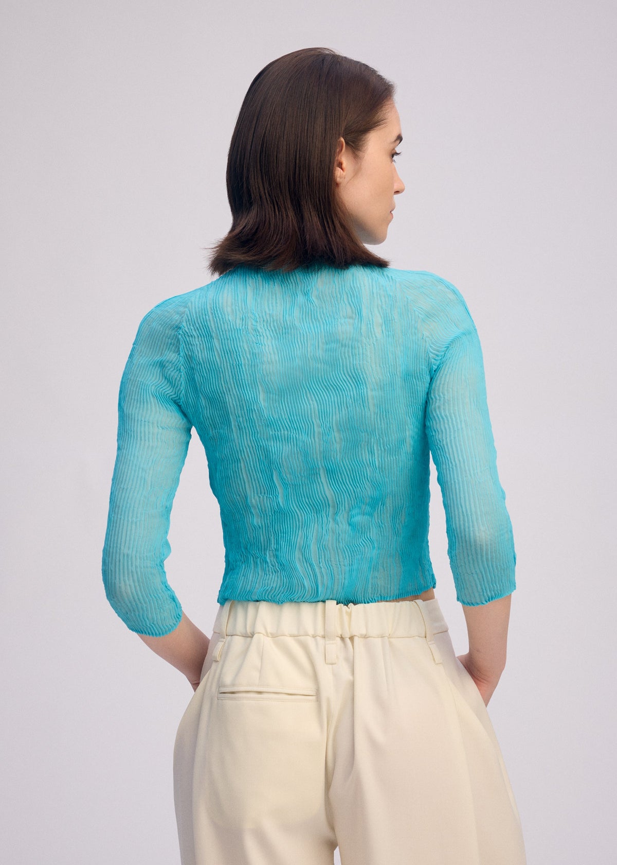A model wears the ISSEY MIYAKE CHIFFON TWIST 2 shirt.