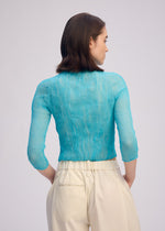 A model wears the ISSEY MIYAKE CHIFFON TWIST 2 shirt.