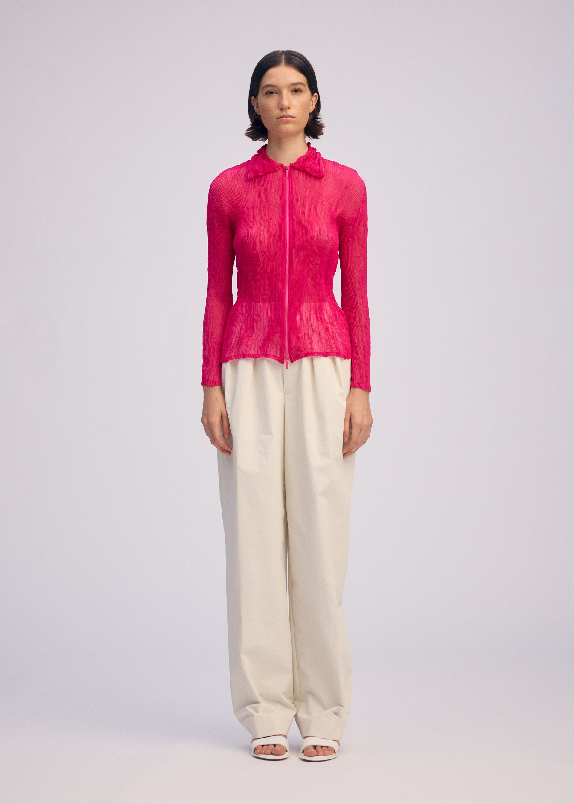 A model wears the ISSEY MIYAKE CHIFFON TWIST 1 clothing.