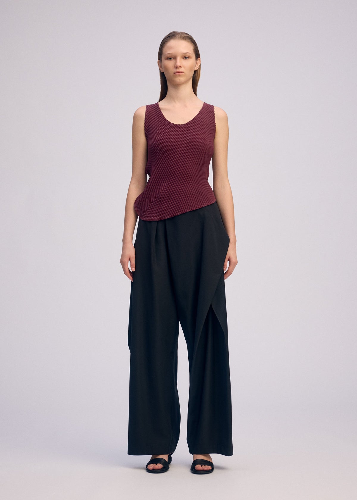 A model wears the ISSEY MIYAKE MISTY PLEATS misty-pleats-shirt-burgundy.