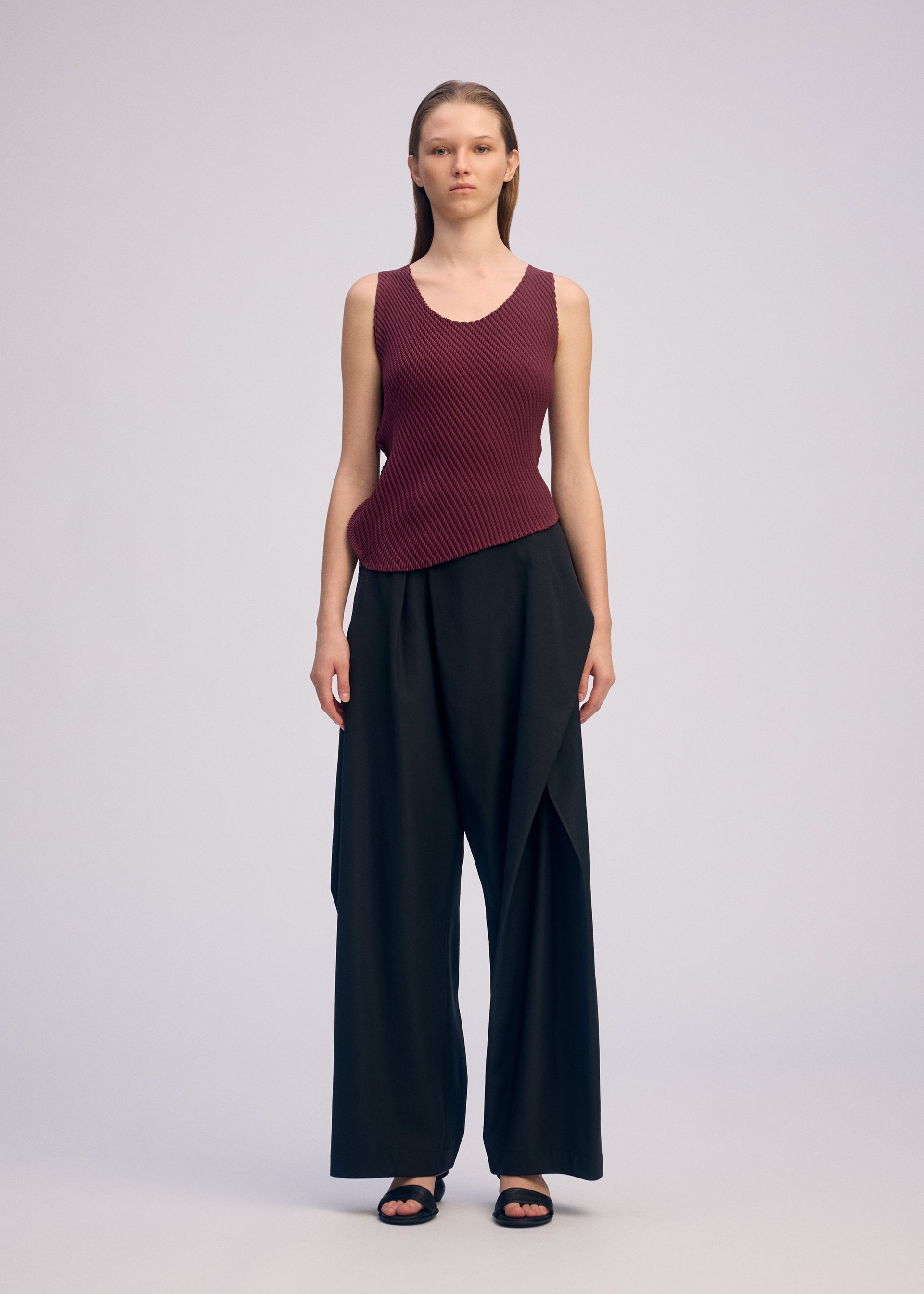 A model wears the ISSEY MIYAKE MISTY PLEATS misty-pleats-shirt-burgundy.