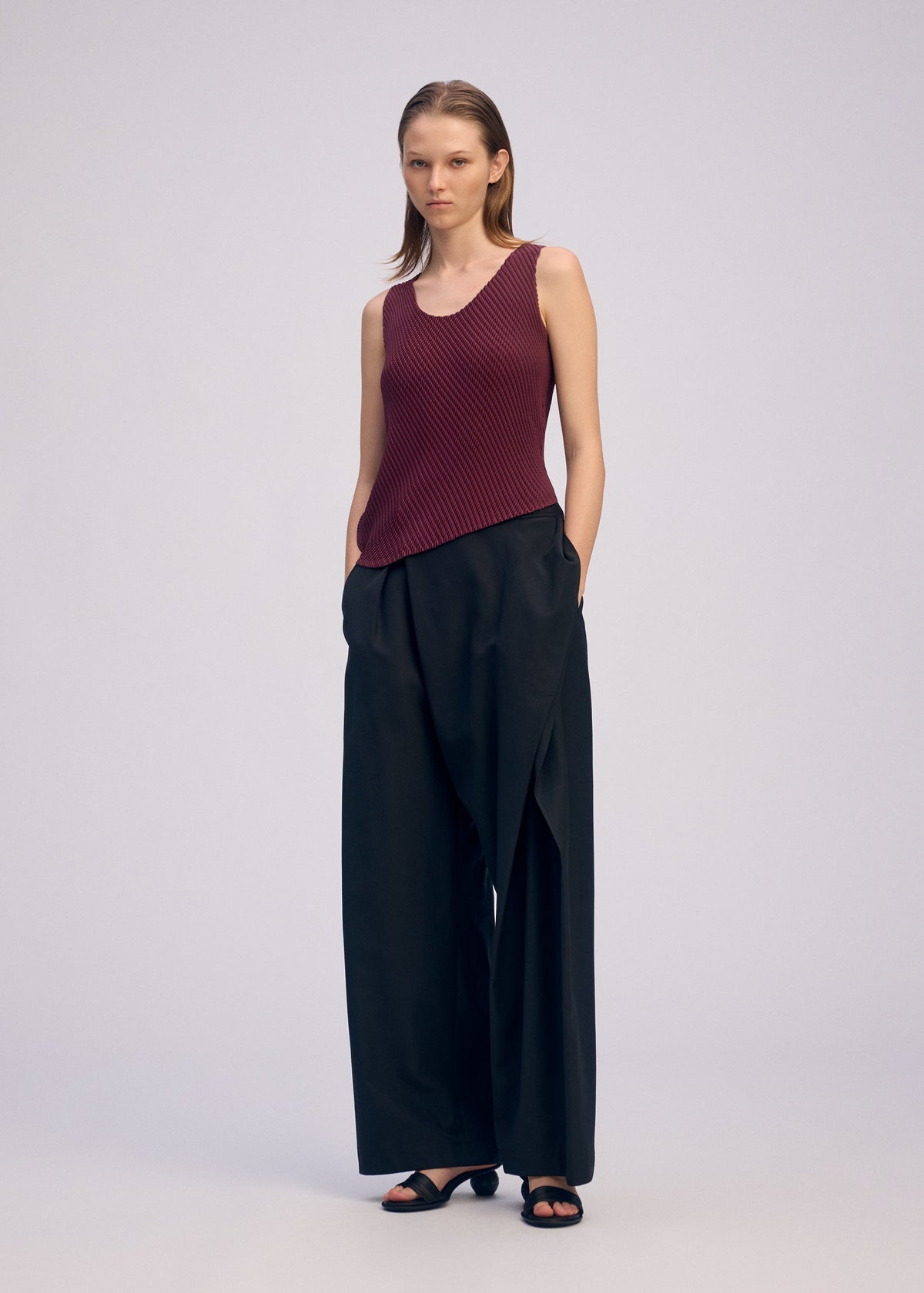 A model wears the ISSEY MIYAKE MISTY PLEATS misty-pleats-shirt-burgundy.
