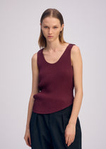 A model wears the ISSEY MIYAKE MISTY PLEATS misty-pleats-shirt-burgundy.