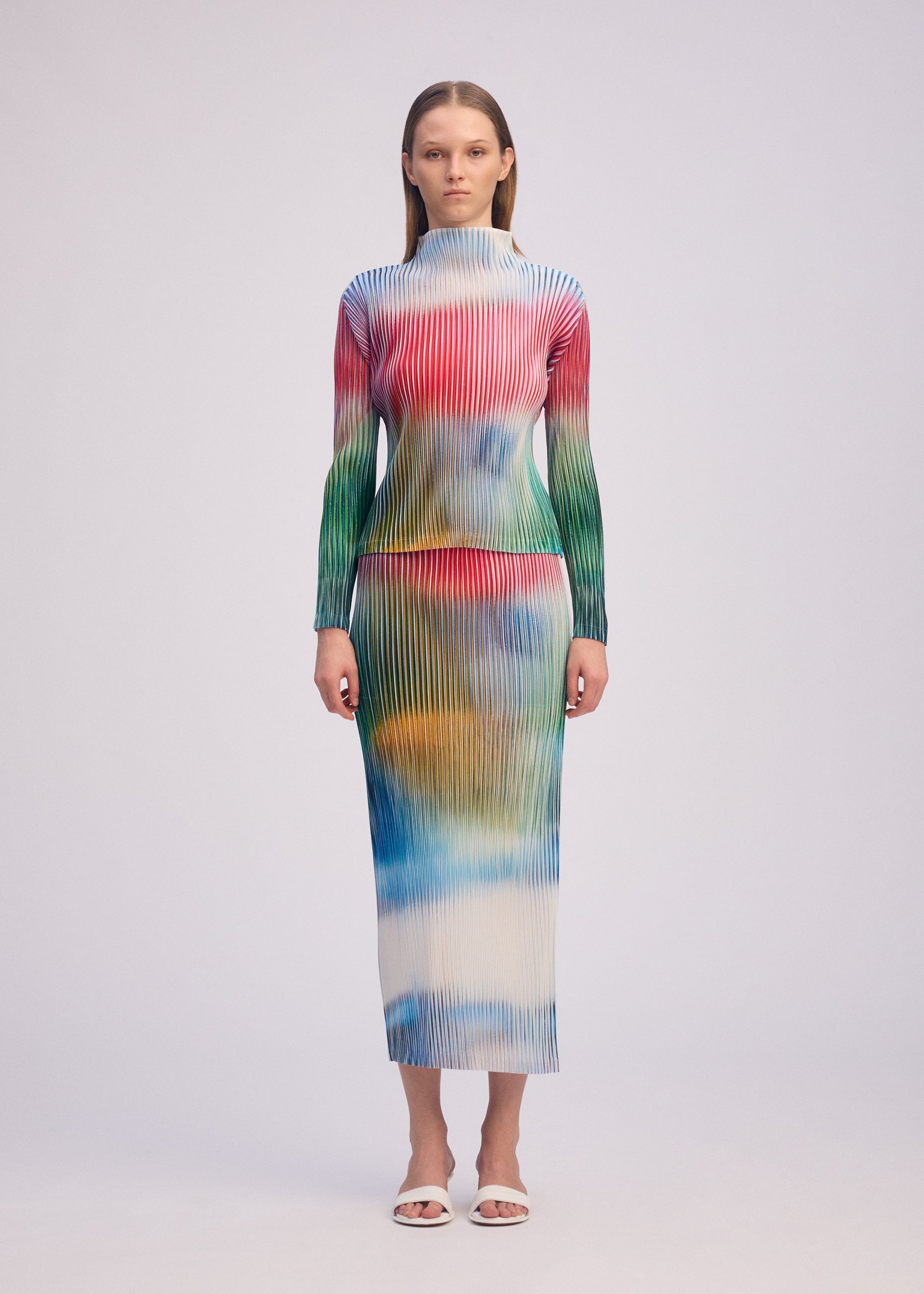 A model wears the ISSEY MIYAKE OBSCURE PLEATS clothing.