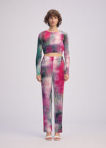 A model wears the ISSEY MIYAKE OBSCURE PLEATS clothing.