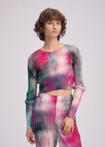 A model wears the ISSEY MIYAKE OBSCURE PLEATS clothing.