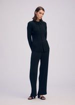 A model wears the ISSEY MIYAKE HATCHING PLEATS shirt.