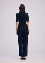 A model wears the ISSEY MIYAKE HATCHING PLEATS shirt.