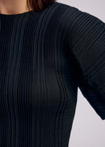 A model wears the ISSEY MIYAKE LINEN LIKE RIB PLEATS shirt.
