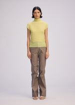 A model wears the ISSEY MIYAKE WOOLY PLEATS 66 clothing.
