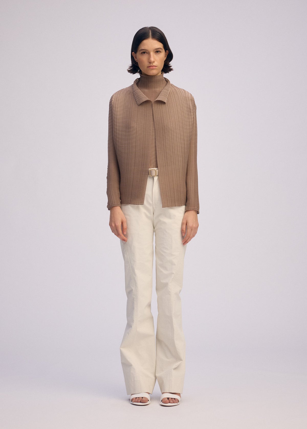 A model wears the ISSEY MIYAKE WOOLY PLEATS 66 clothing.