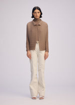 A model wears the ISSEY MIYAKE WOOLY PLEATS 66 clothing.