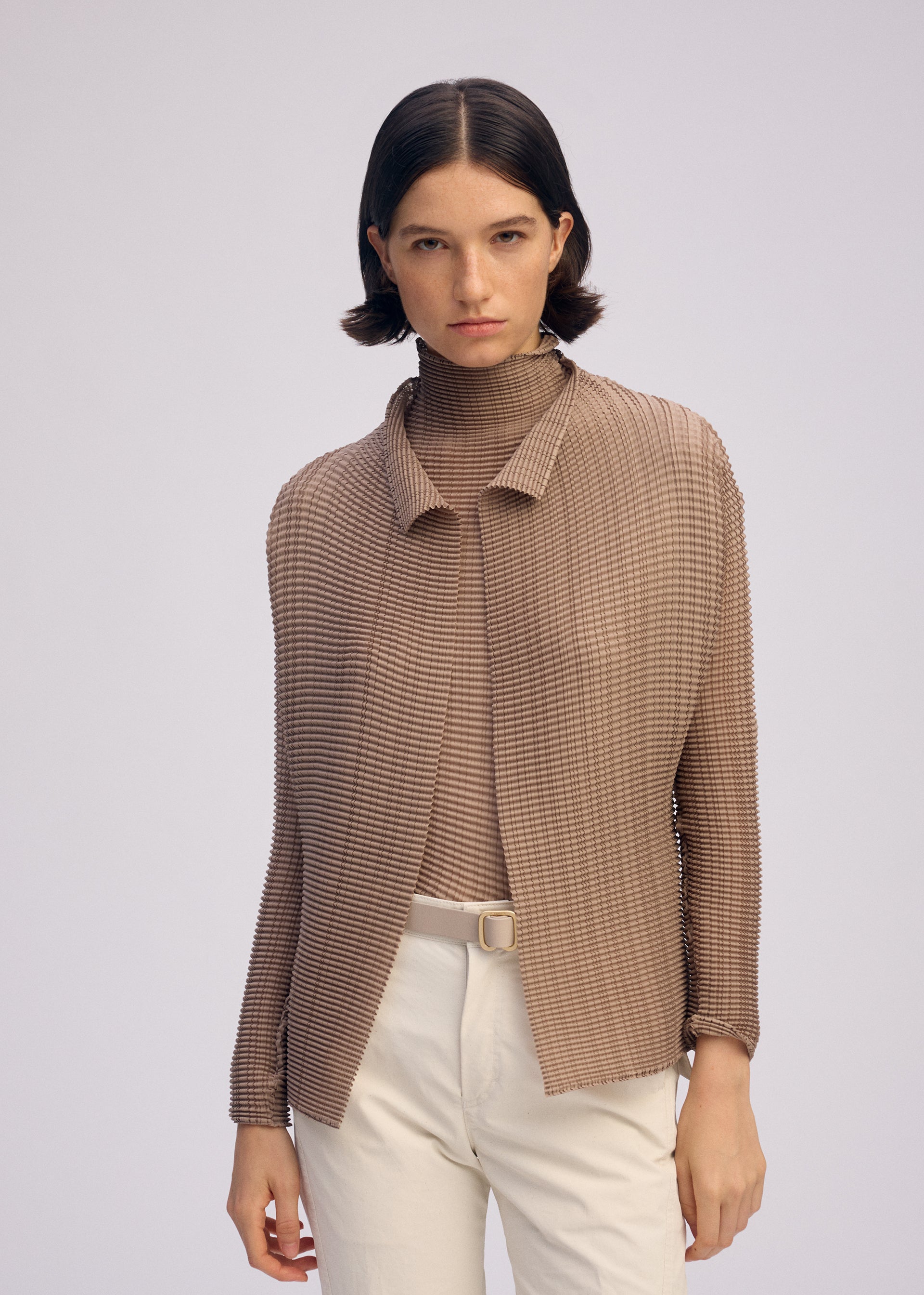 A model wears the ISSEY MIYAKE WOOLY PLEATS 66 clothing.