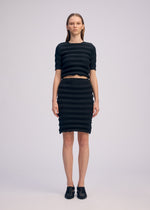 A model wears the ISSEY MIYAKE SPRING PLEATS spring-pleats-shirt-starling-blue.
