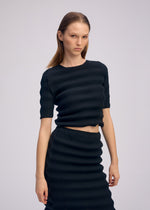 A model wears the ISSEY MIYAKE SPRING PLEATS spring-pleats-shirt-starling-blue.