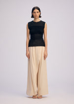 A model wears the ISSEY MIYAKE SHEER FUZZY PLEATS shirt.