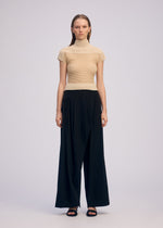A model wears the ISSEY MIYAKE SHEER FUZZY PLEATS shirt.