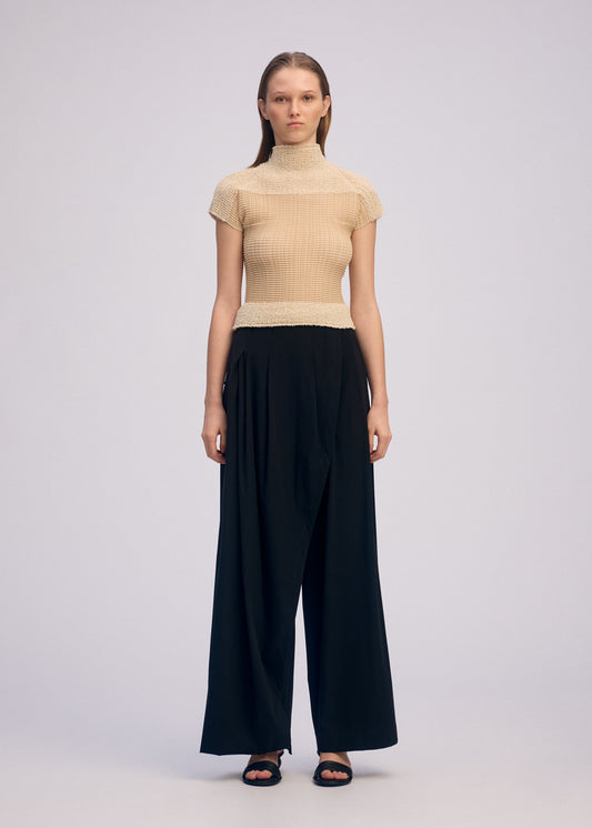 A model wears the ISSEY MIYAKE SHEER FUZZY PLEATS shirt.