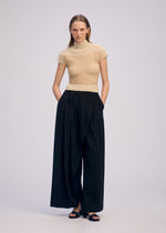 A model wears the ISSEY MIYAKE SHEER FUZZY PLEATS shirt.