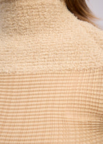 A model wears the ISSEY MIYAKE SHEER FUZZY PLEATS shirt.