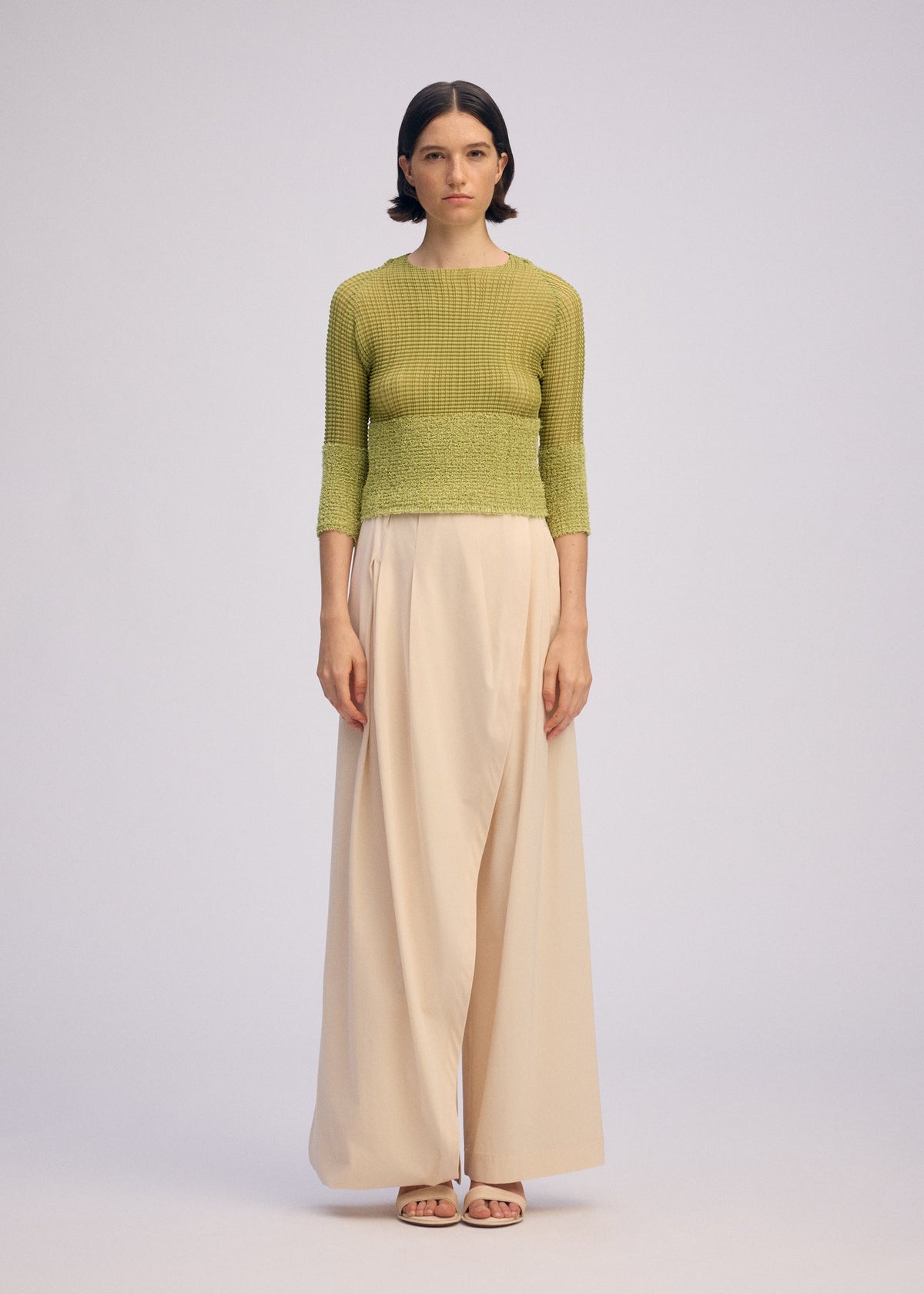 A model wears the ISSEY MIYAKE SHEER FUZZY PLEATS shirt.