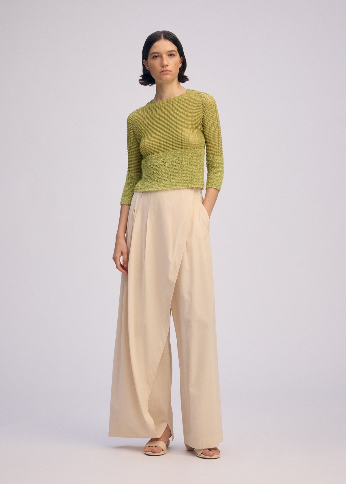 A model wears the ISSEY MIYAKE SHEER FUZZY PLEATS shirt.