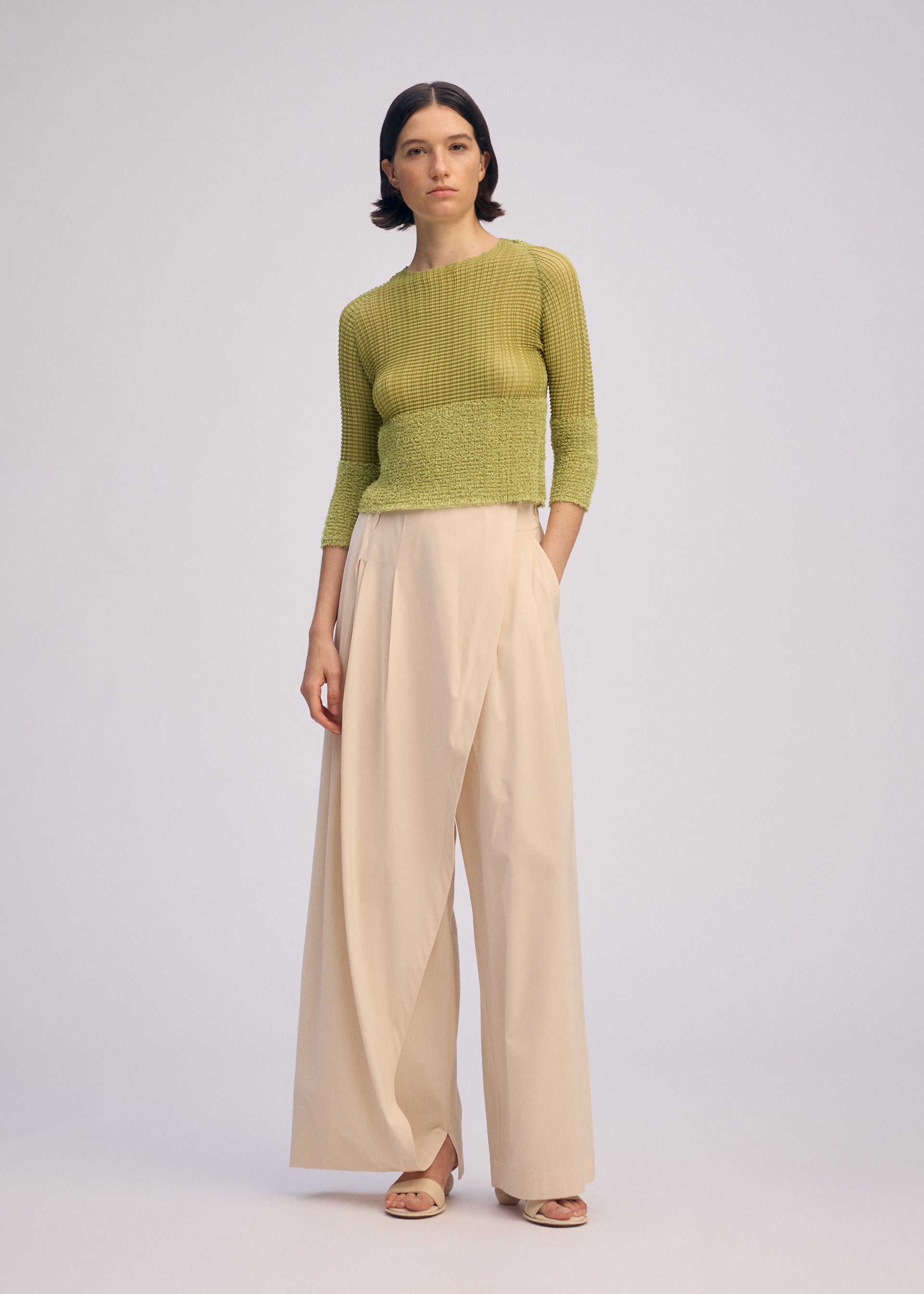 A model wears the ISSEY MIYAKE SHEER FUZZY PLEATS shirt.