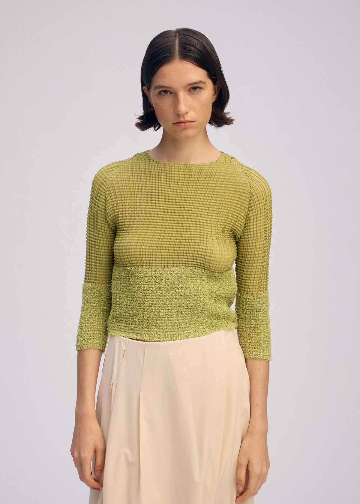 A model wears the ISSEY MIYAKE SHEER FUZZY PLEATS shirt.