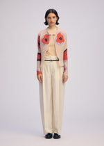 A model wears the ISSEY MIYAKE VERVE PLEATS TOP shirt.