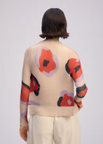 A model wears the ISSEY MIYAKE VERVE PLEATS TOP shirt.