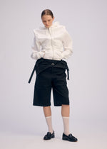 A model wears the ISSEY MIYAKE GENERIC WEAR cardigan.