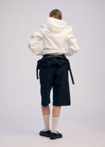 A model wears the ISSEY MIYAKE GENERIC WEAR cardigan.