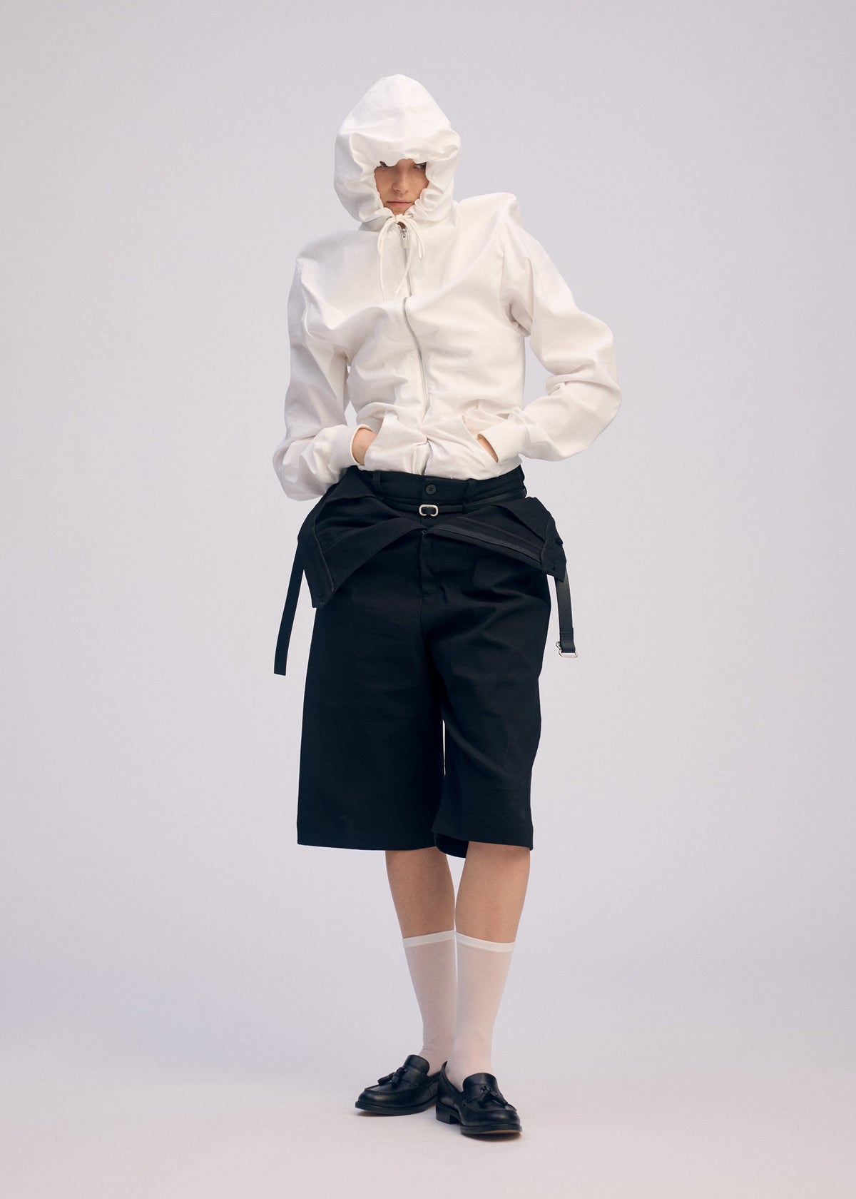 A model wears the ISSEY MIYAKE GENERIC WEAR cardigan.