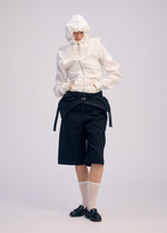 A model wears the ISSEY MIYAKE GENERIC WEAR cardigan.