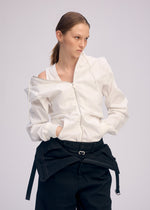 A model wears the ISSEY MIYAKE GENERIC WEAR cardigan.