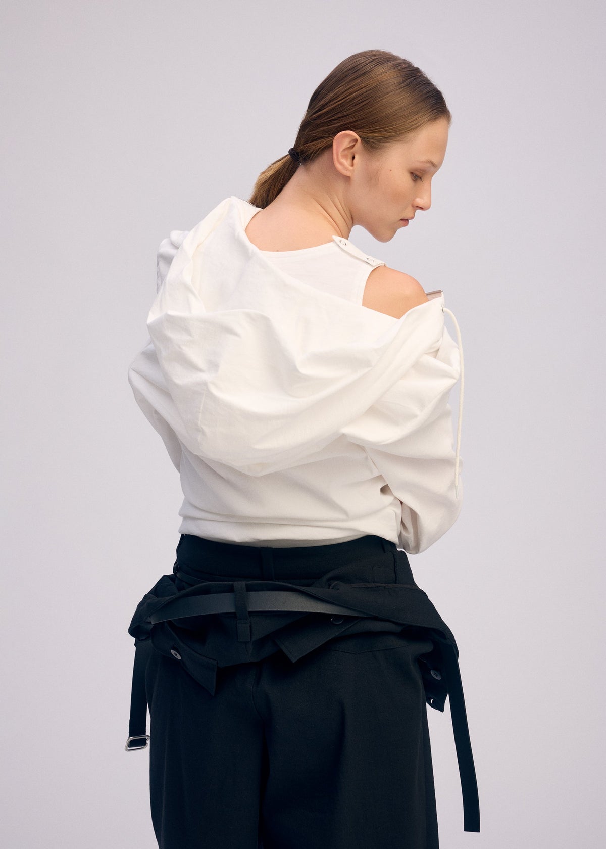 A model wears the ISSEY MIYAKE GENERIC WEAR cardigan.