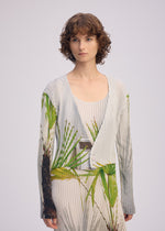 A model wears the ISSEY MIYAKE URBAN JUNGLE PLEATS cardigan.