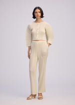 A model wears the ISSEY MIYAKE LINEN LIKE RIB PLEATS cardigan.