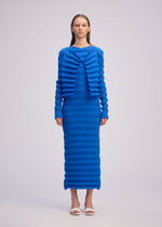 A model wears the ISSEY MIYAKE SPRING PLEATS spring-pleats-cardigan-black.