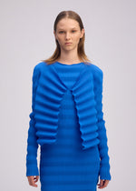 A model wears the ISSEY MIYAKE SPRING PLEATS spring-pleats-cardigan-black.