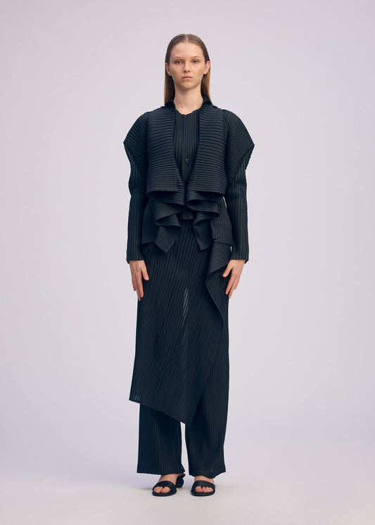 A model wears the ISSEY MIYAKE PLEATED ON PLEATS cardigan.