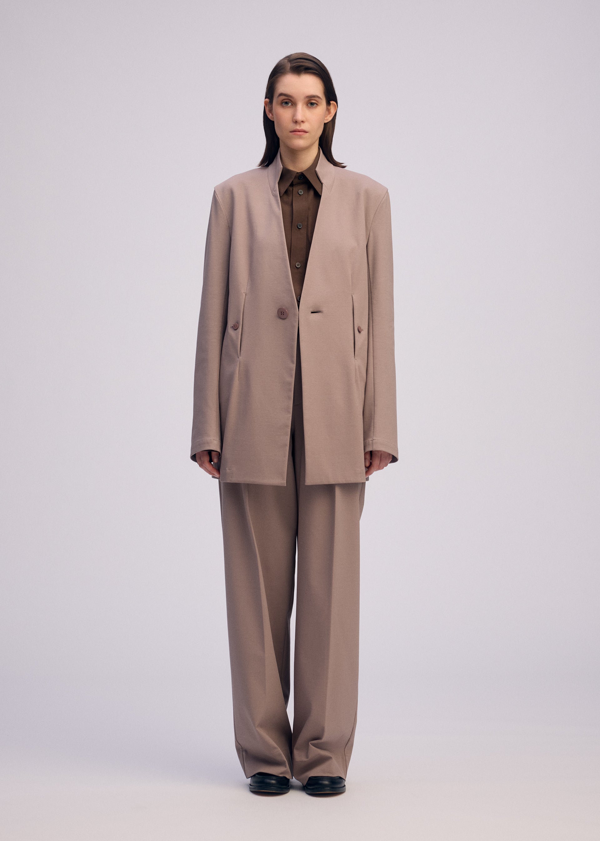 A model wears the ISSEY MIYAKE SIMPLE ENSEMBLE clothing.