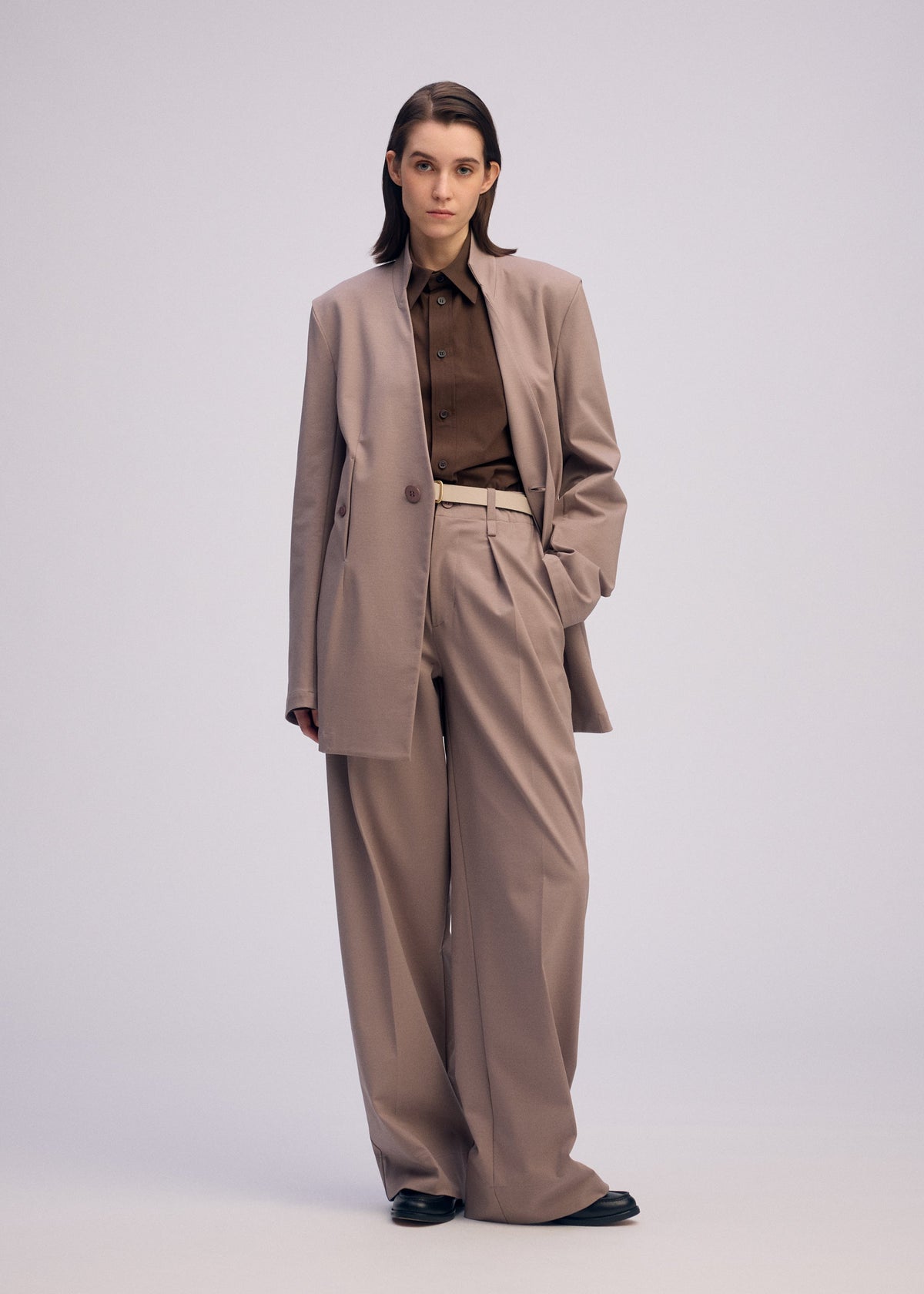 A model wears the ISSEY MIYAKE SIMPLE ENSEMBLE clothing.