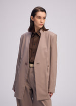 A model wears the ISSEY MIYAKE SIMPLE ENSEMBLE clothing.