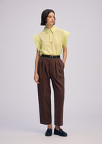 A model wears the ISSEY MIYAKE SIMPLE ENSEMBLE clothing.