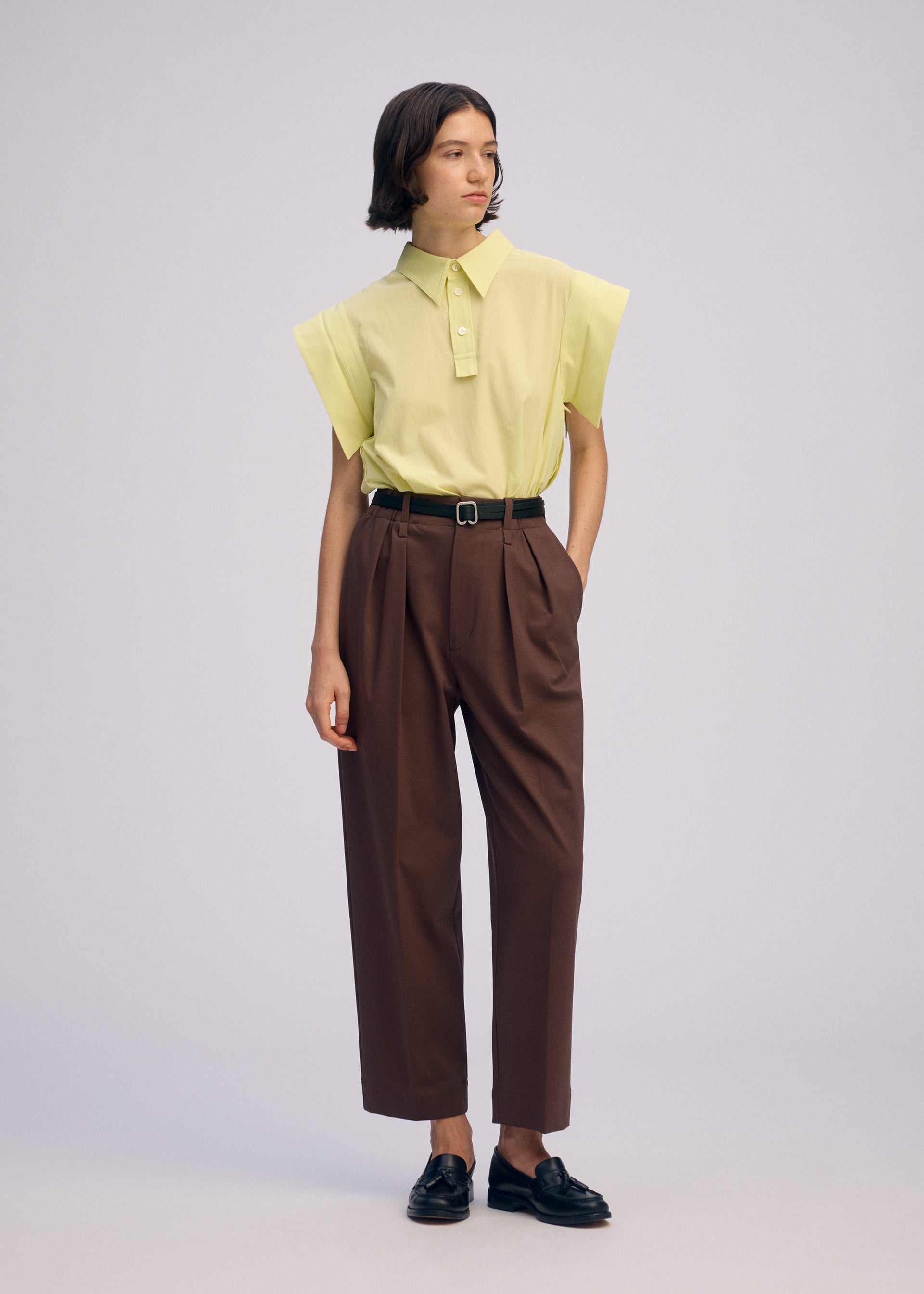 A model wears the ISSEY MIYAKE SIMPLE ENSEMBLE clothing.