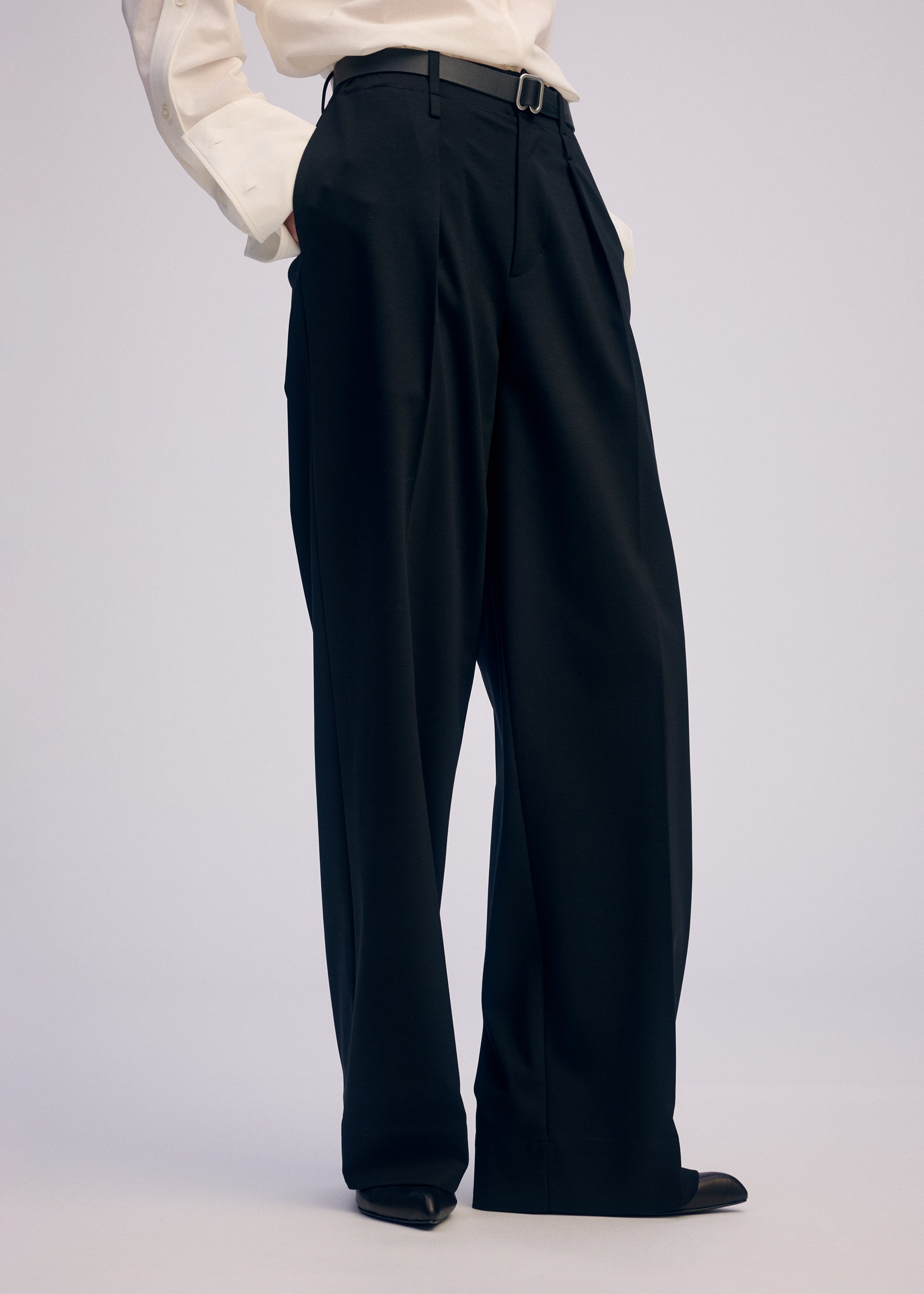 A model wears the ISSEY MIYAKE SIMPLE ENSEMBLE clothing.